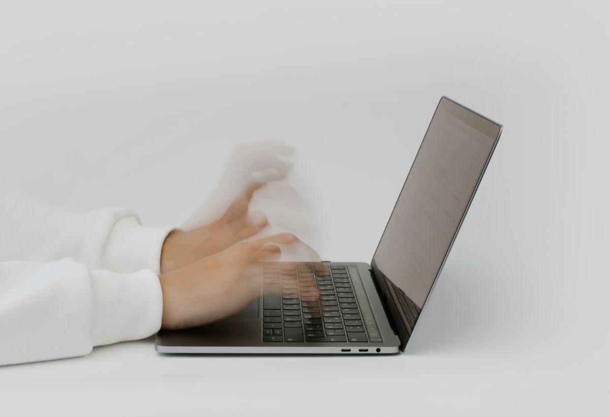 Hands building software on a keyboard